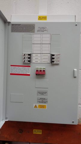 contractors replace electrical fuse box in a Essex school
